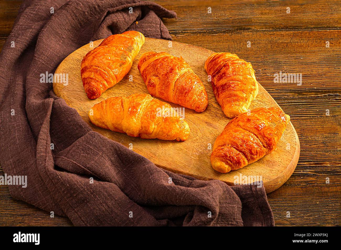 Delicious Croissants on Wooden Board Stock Photo