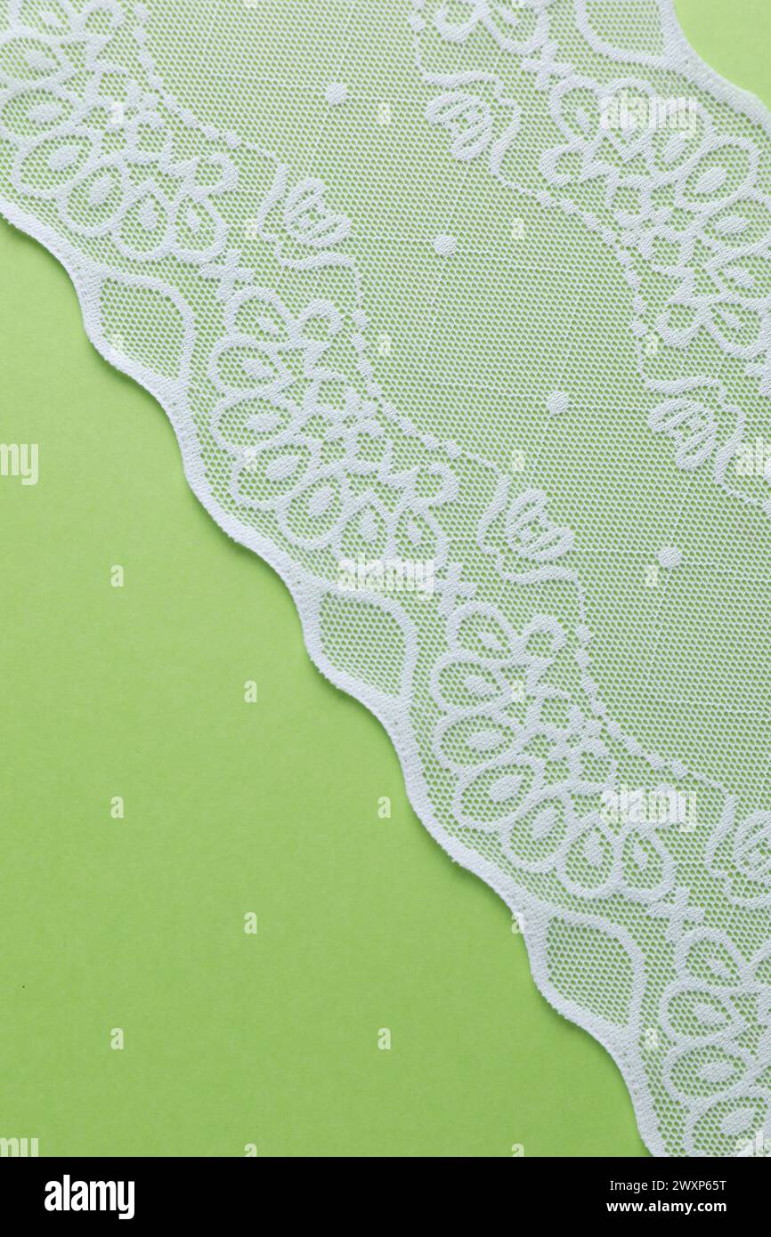 White lace on green background, top view Stock Photo