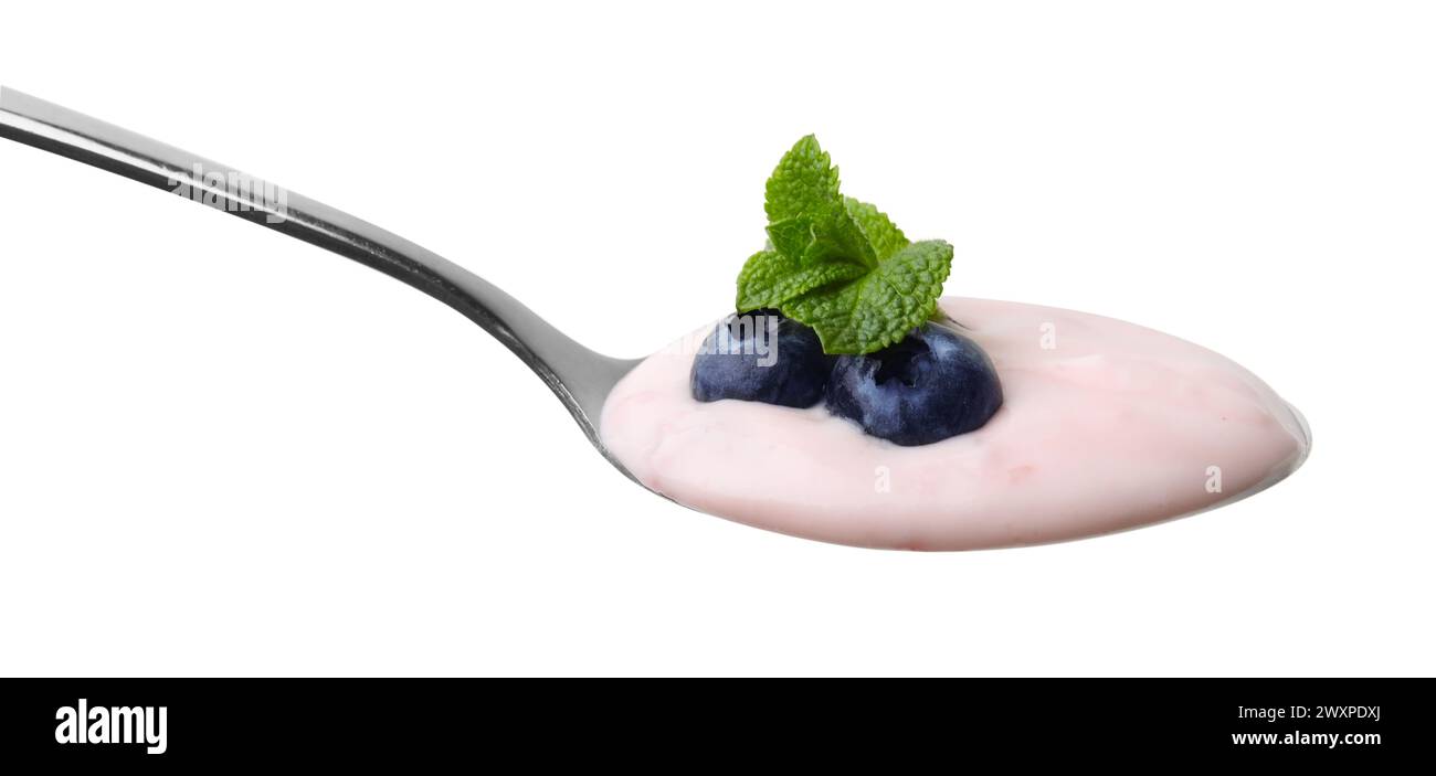 Spoon with yogurt, blueberries and mint isolated on white Stock Photo