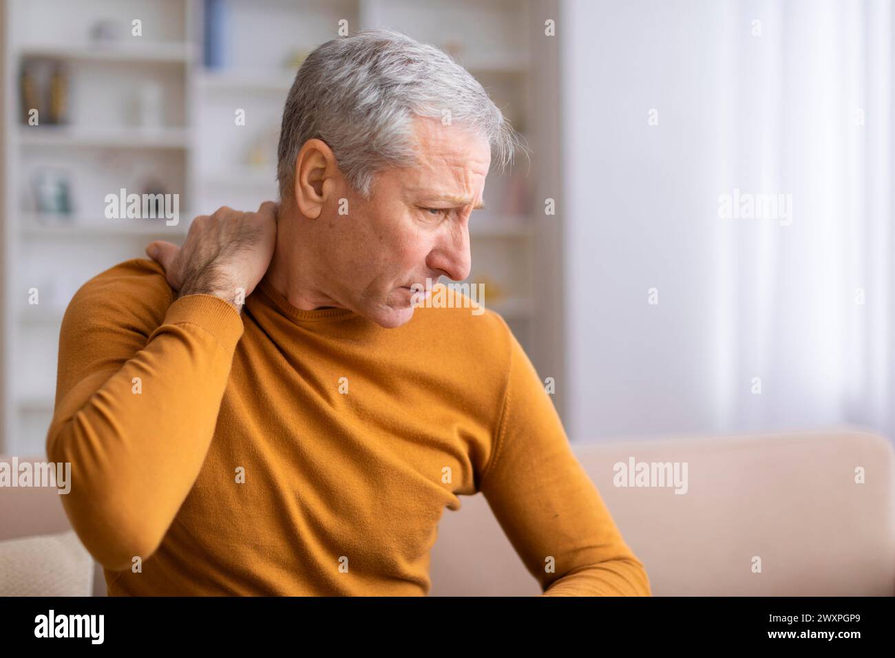 Senior man suffering from shoulder pain Stock Photo