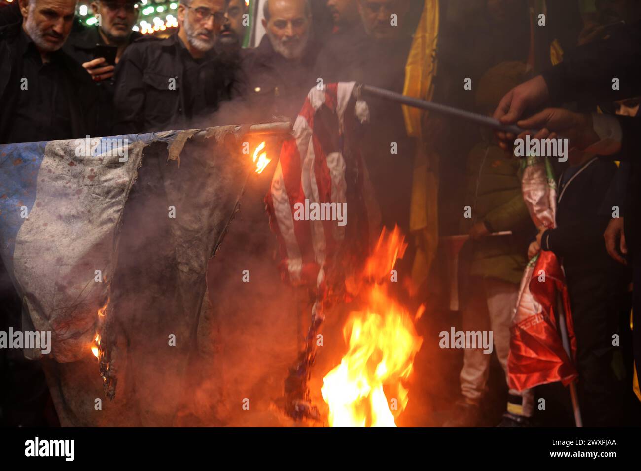 Tehran, Iran. 1st Apr, 2024. Iranians burn Israel and US flags during an anti-Israeli demonstration at Palestine Square in Tehran. Israel on 01 April launched an airstrike targeting the Iranian consulate building in Damascus. An Israeli airstrike that demolished Iran's consulate in Syria killed two Iranian generals and five officers. The attack in Syria killed Gen. Mohammad Reza Zahedi, an Iranian senior military officer in the Islamic Revolutionary Guard Corps (IRGC) and one of the top commanders of the Quds Force. Credit: ZUMA Press, Inc./Alamy Live News Stock Photo