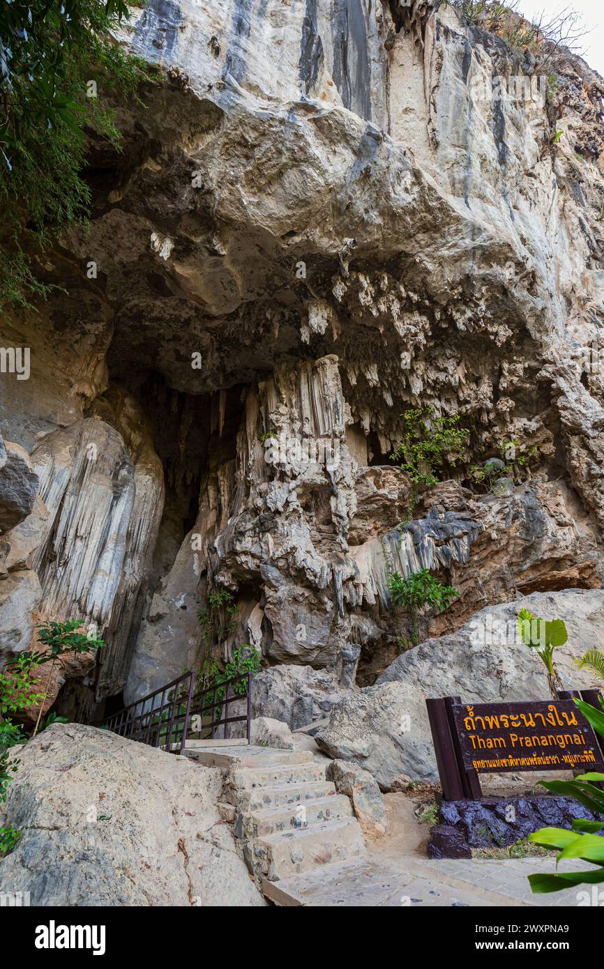 View of the entrance to the Diamond Cave (Tham Phra Nang Nai) on a steep and stunning limestone cliff in Railay, Krabi, Thailand. Stock Photo