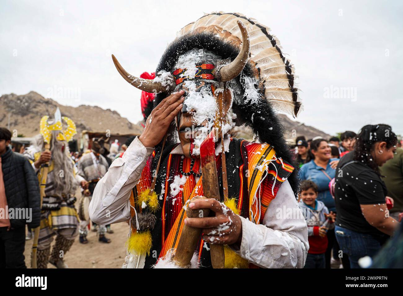 Holy Week Masks HERMOSILLO, MEXICO - MARCH 30: A pilgrim with a Pharisee mask wipes the ...