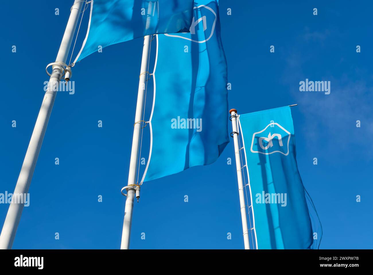 Albert Heijn logo on tree blue banners. Albert Heijn is the largest supermarket chain in the Netherlands and also has branches in Belgium. Stock Photo