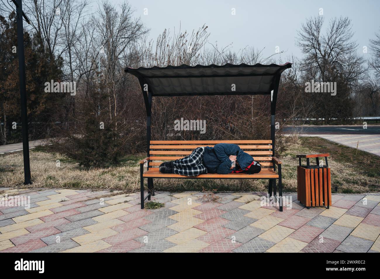 homeless elderly old man lies sleeping on a park bench in autumn Stock ...