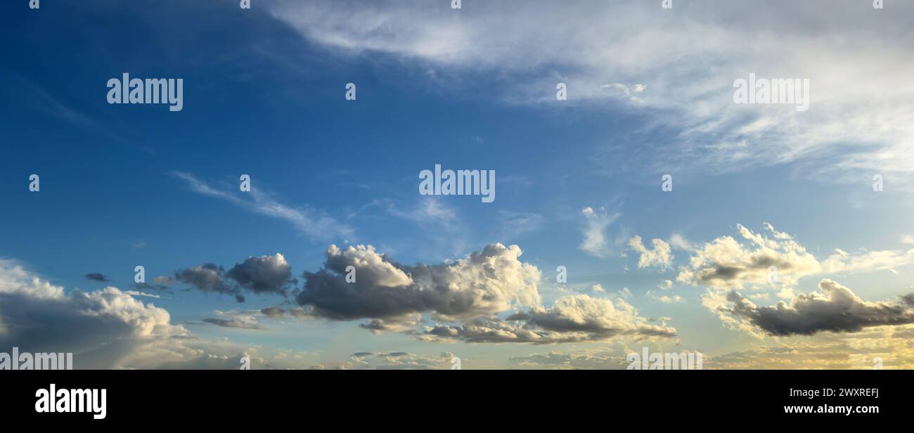 White and grey fluffy cloud in many shape against clear sky background texture. Stormy cumulus in blue heaven. Wallpaper, banner. Copy space Stock Photo