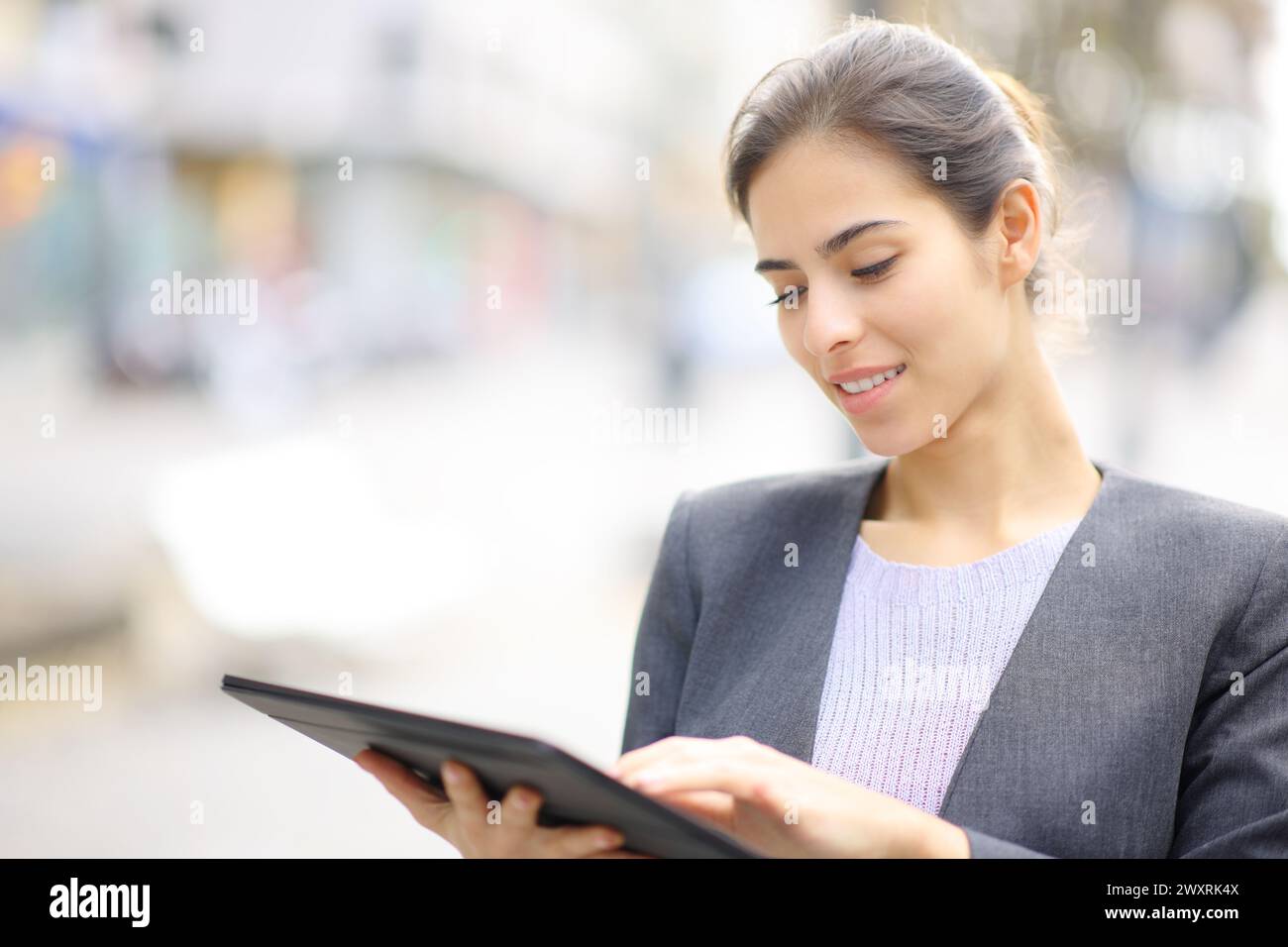 Executive using tablet standing in the street Stock Photo