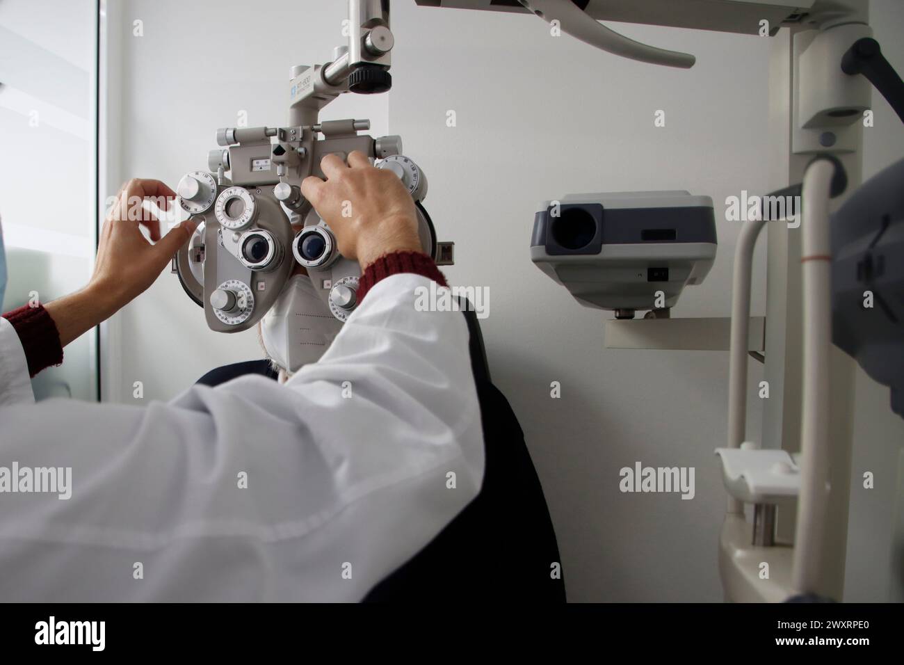 A medical professional using a camera to examine screen data Stock Photo
