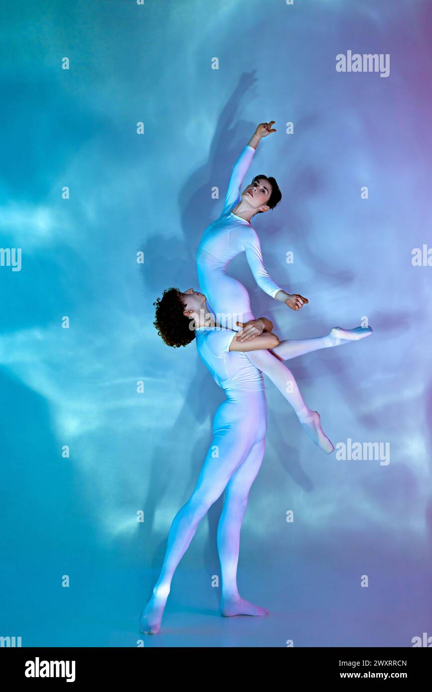 Artistic, talented male and female ballet dancers in pastel leotards