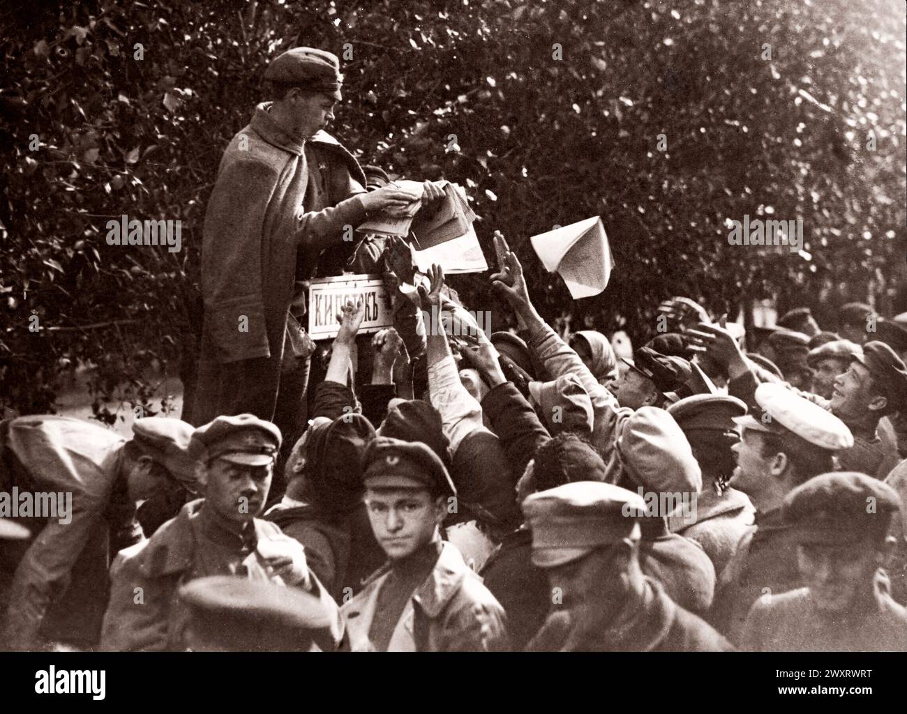 Man Distibuting Newspapers to Crowd Russia 1917 - 1918 Stock Photo