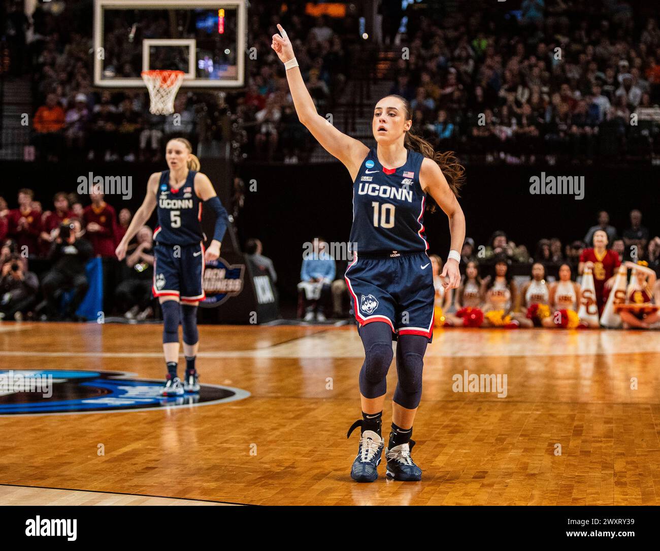 Portland, OR U.S. 01st Apr, 2024. A. UConn guard Nika Muhl (10)reacts after hitting a 3 point shot during the NCAA Women's Basketball Regional Elite 8 game 2 between USC Trojans and the UConn Huskies. UConn beat USC 80-73 to advance to the final four. Moda Center Portland, OR. Thurman James/CSM/Alamy Live News Stock Photo