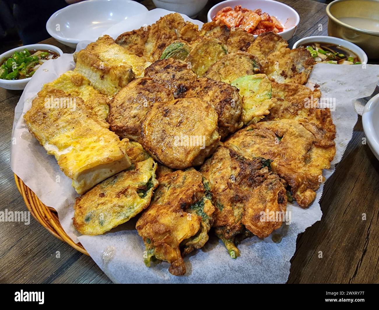 Jeon, a fritter in Korean cuisine made by seasoning whole, sliced, or minced fish, meat, vegetables, etc., and coating them with wheat flour and egg w Stock Photo