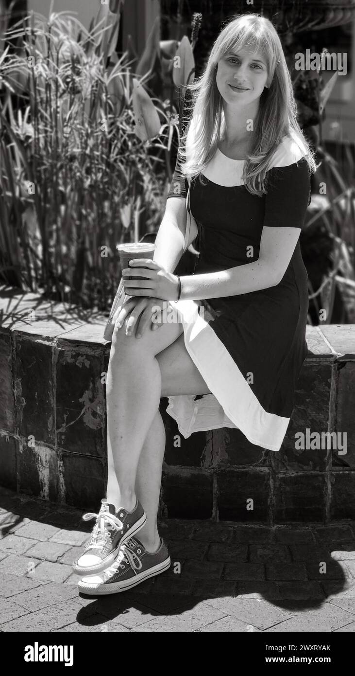 Charming blonde woman sitting hi-res stock photography and images - Alamy