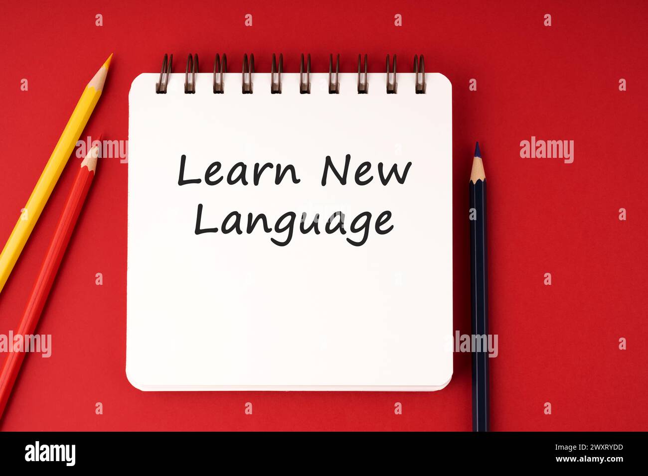 Learn new language text on notepad on red background Stock Photo