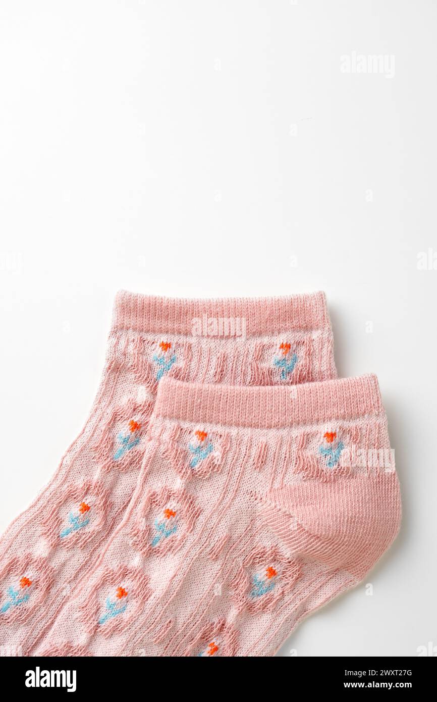 Pink socks with pattern on white background Stock Photo
