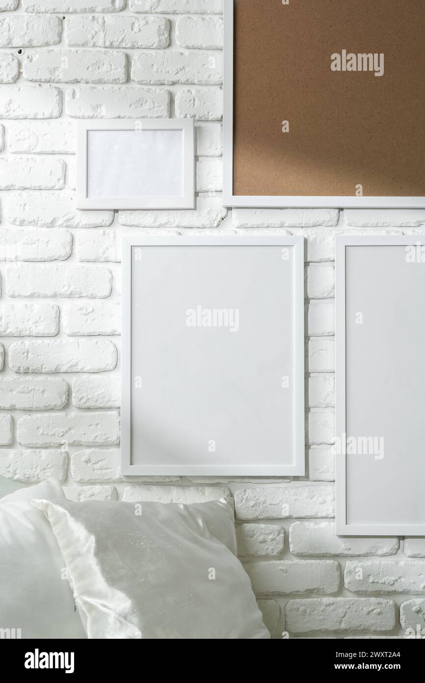 Varied Sized Photo Frames Displayed on a White Brick Wall Stock Photo ...