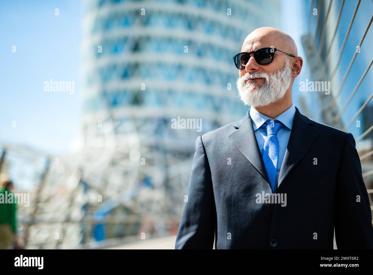 Mature bald stylish business man portrait with a white beard outdoor wearing sunglasses Stock Photo