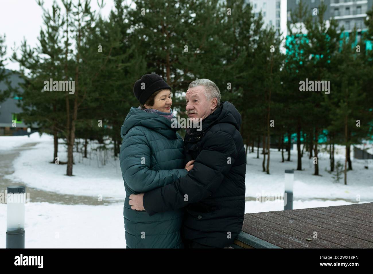 Happy elderly couple walking in the park and confessing their feelings ...