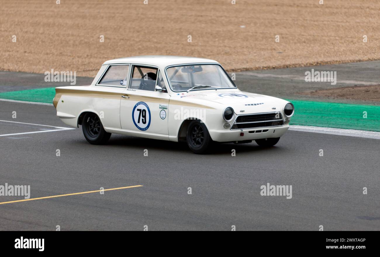 Mark Drain driving his White, 1965, Ford Lotus Cortina, during the Adrian Flux Trophy for Transatlantic Pre'66 Touring Cars. Stock Photo