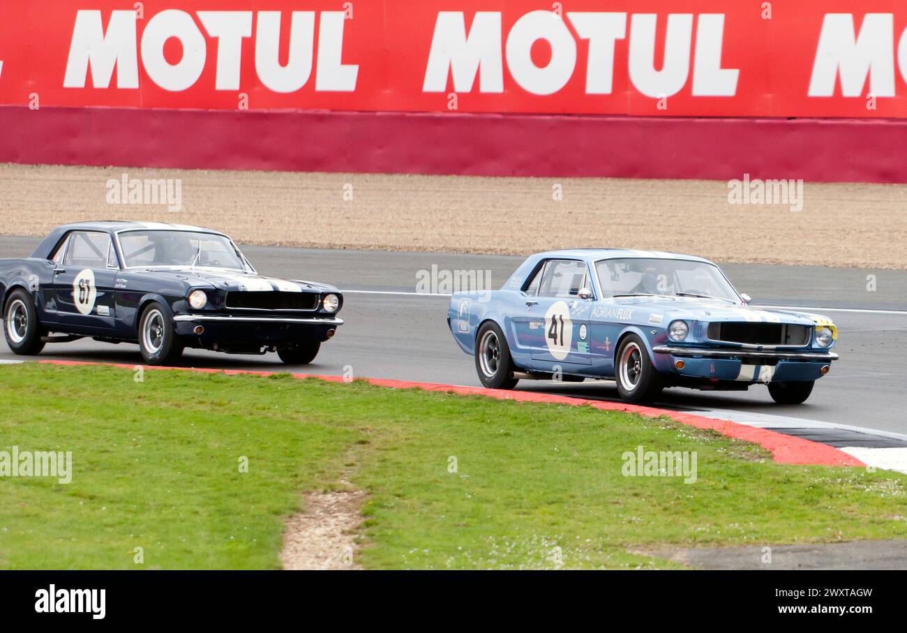 James Thorp's Mustang (67) battling with Sir Chris Hoy's Mustang (41) during the Adrian Flux Trophy for Transatlantic Pre '66 Touring Cars Race Stock Photo