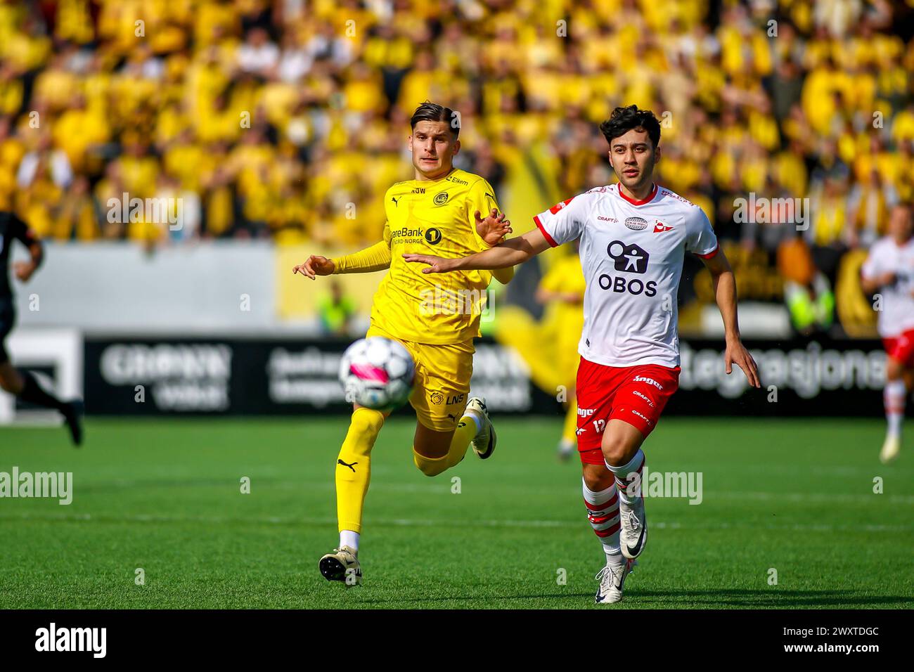 Fredrikstad, Norway, 1st April 2024.  Bodø/Glimt's Nino Zugelj and Fredrikstad's Patrick Metcalfe duells for the ball in the Eliteserien match between Fredrikstad and Bodø/Glimt at Fredrikstad stadium.   Credit: Frode Arnesen/Alamy Live News Stock Photo