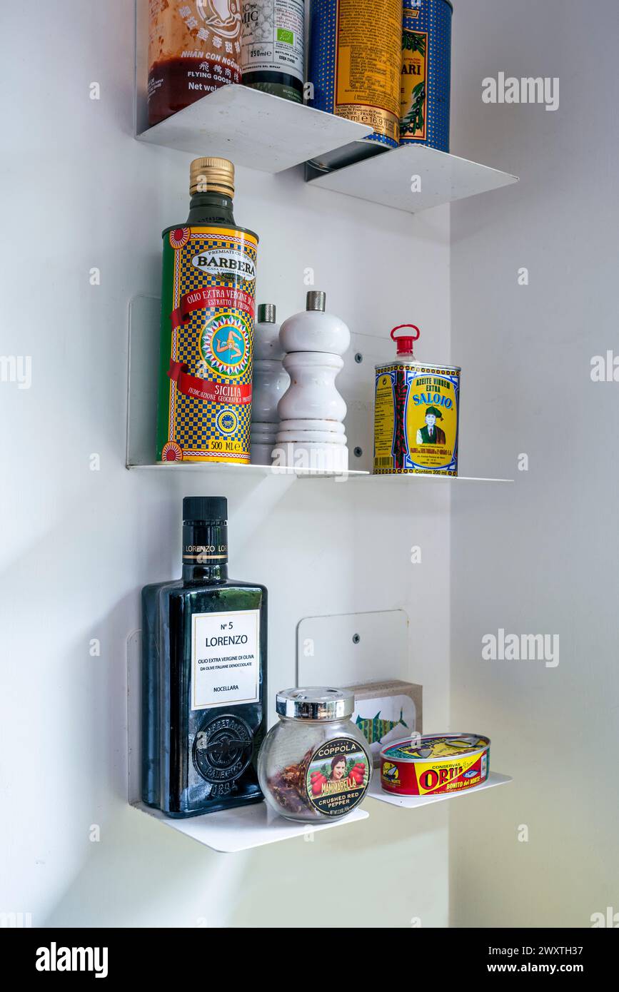 Bottles and vintage tins on shelf in East London kitchen, UK Stock Photo