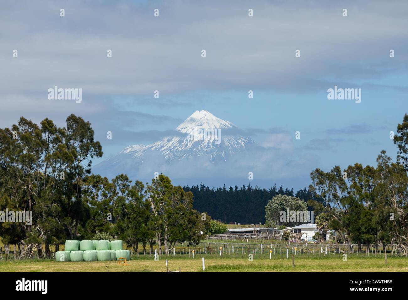 Snow covers  Mount Taranaki, also called Mt Egmont, a dormant stratovolcano on the west coast of New Zealand's North Island. At 2,518 metres, it is th Stock Photo
