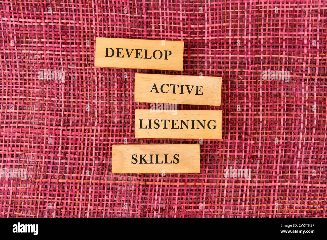 Concept word Develop active listening skills on wooden blocks on a mesh ...