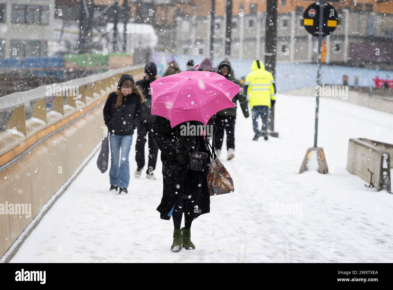 Stockholm, Sweden. 02nd Apr, 2024. Pedestrians make their way in the snowy weather in Stockholm
