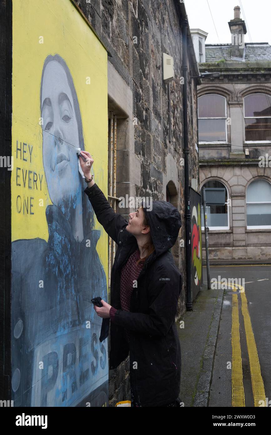Edinburgh Scotland, UK 02 April 2024.  Artist Anna Dittmann in Leith where she cleans her mural which was covered in blue paint.  credit sst/alamy live news Stock Photo