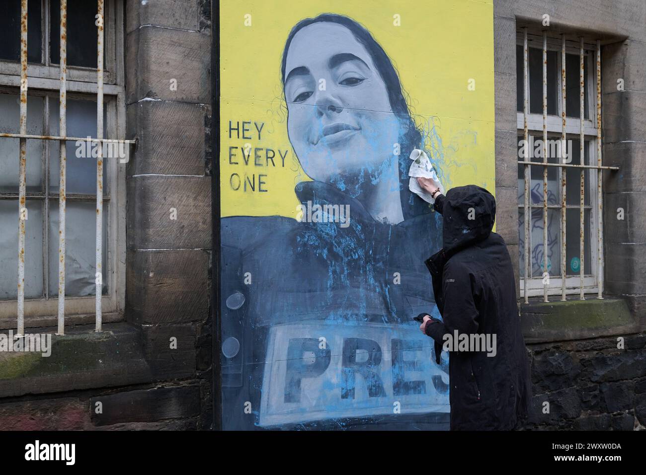 Edinburgh Scotland, UK 02 April 2024.  Artist Anna Dittmann in Leith where she cleans her mural which was covered in blue paint.  credit sst/alamy live news Stock Photo