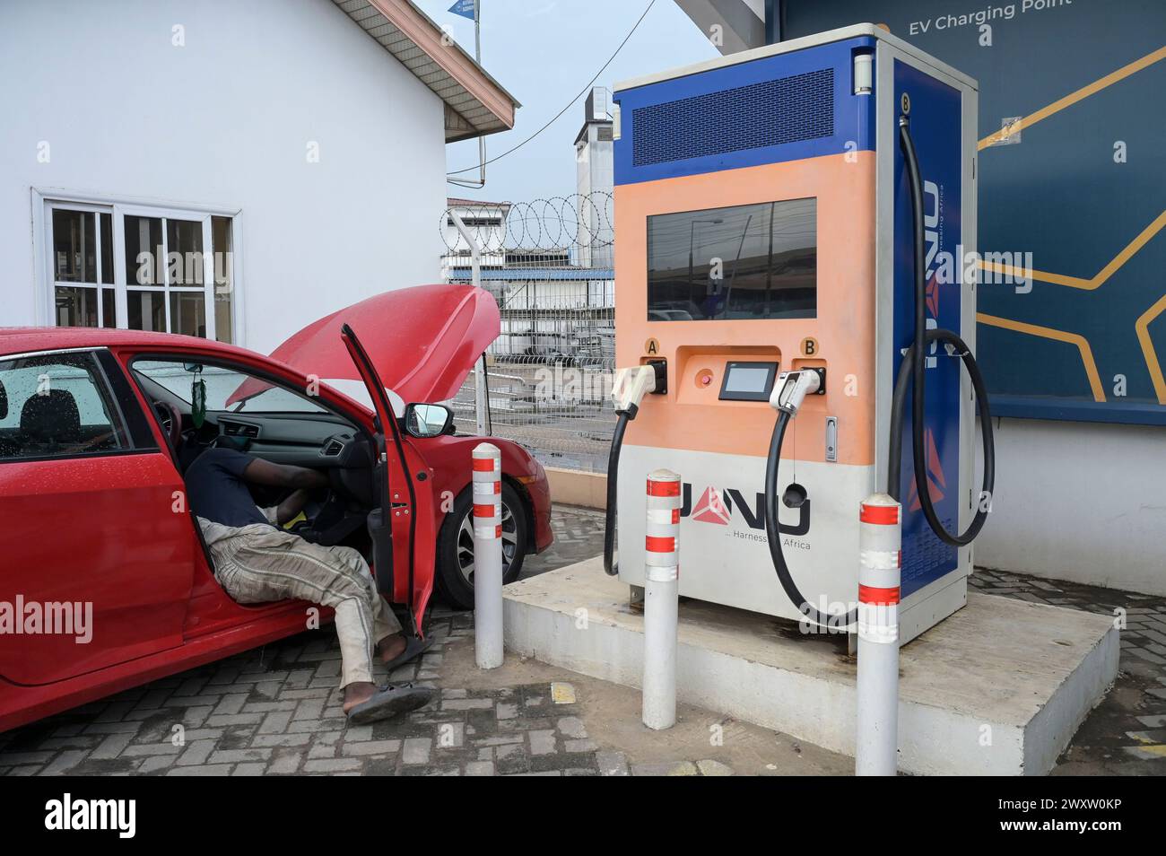 GHANA, Accra, electric mobility, IJANU service and quick charging station for electric cars, quick charger station with Tesla plug, left / GHANA, Accra, E-Mobilität, IJANU Service und Ladestation für E-Autos, Quick-charger Stock Photo