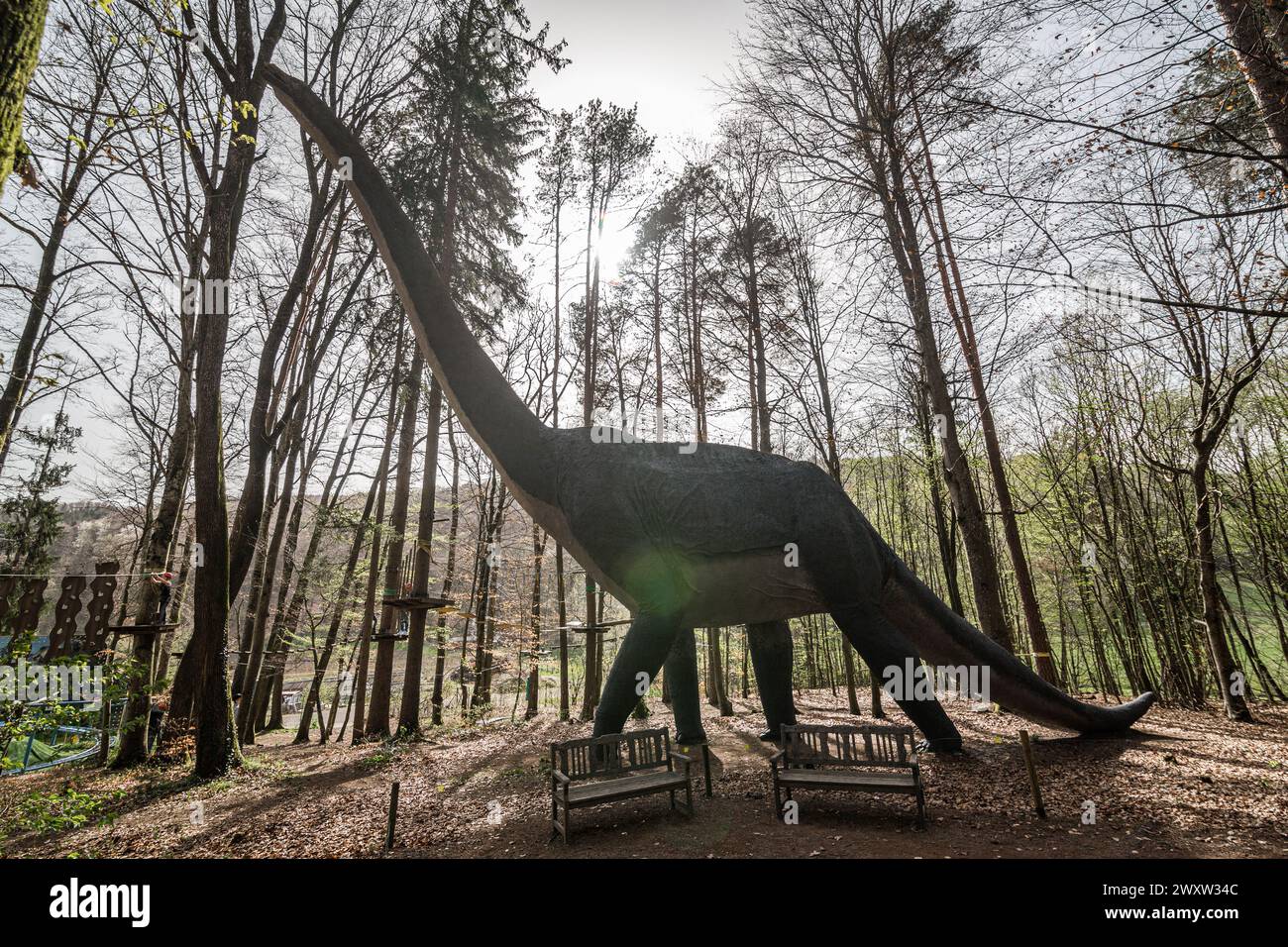 A dinosaur replica in a forest Stock Photo