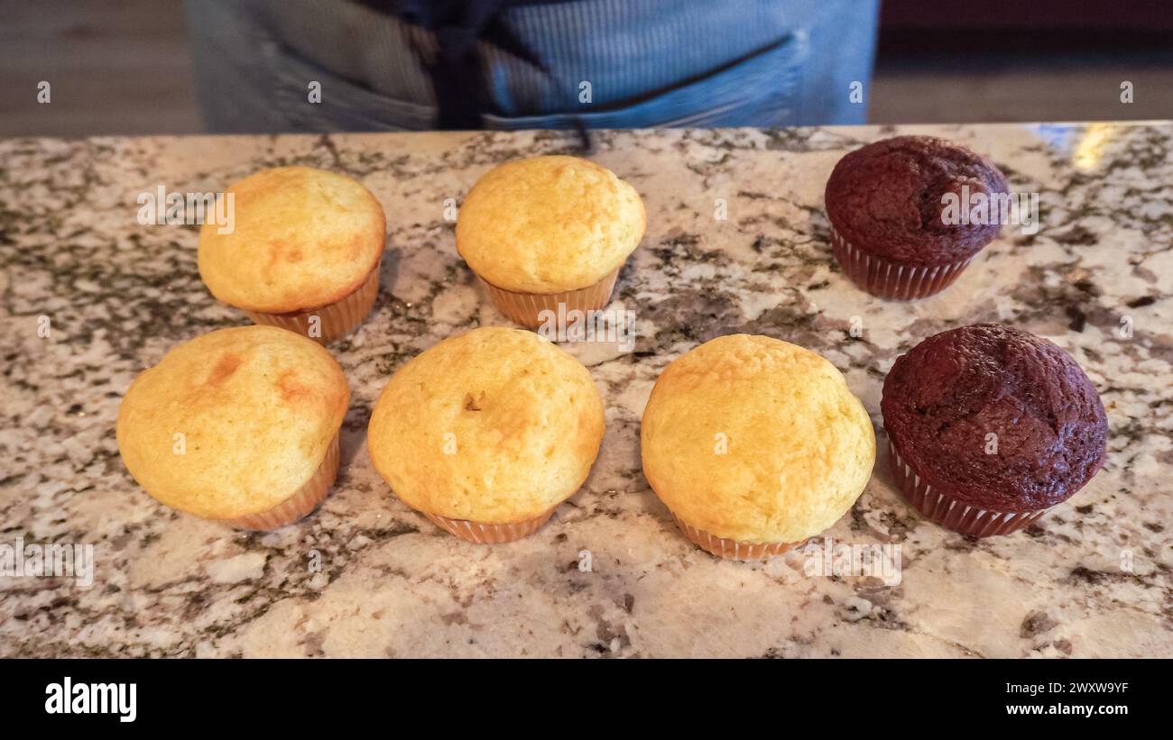 Filling Vanilla, Chocolate Cupcakes with Lemon, Raspberry Stock Photo