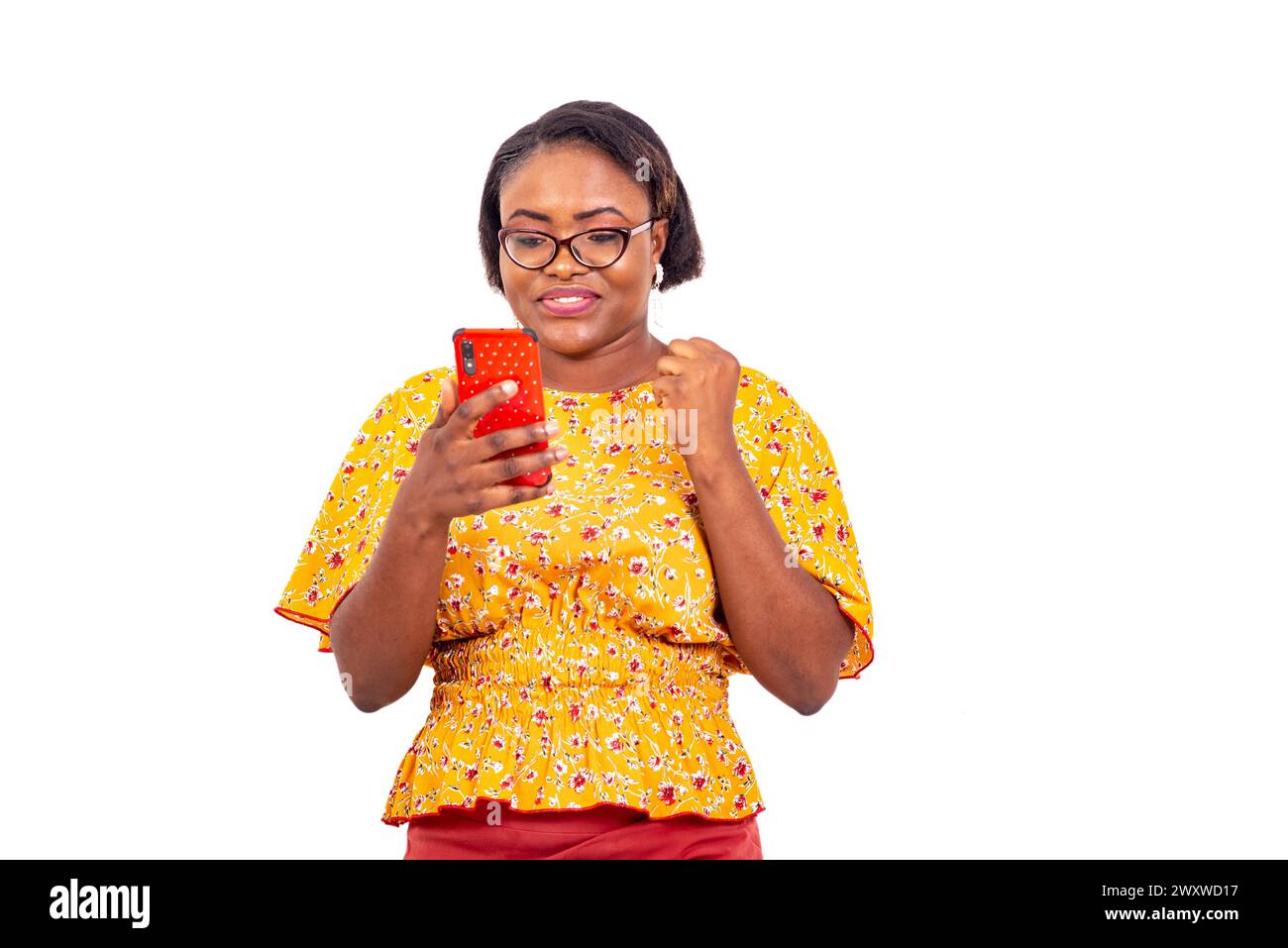 a beautiful business woman in eyeglasses standing over white background communicating on the cellphone while showing victory gesture. Stock Photo