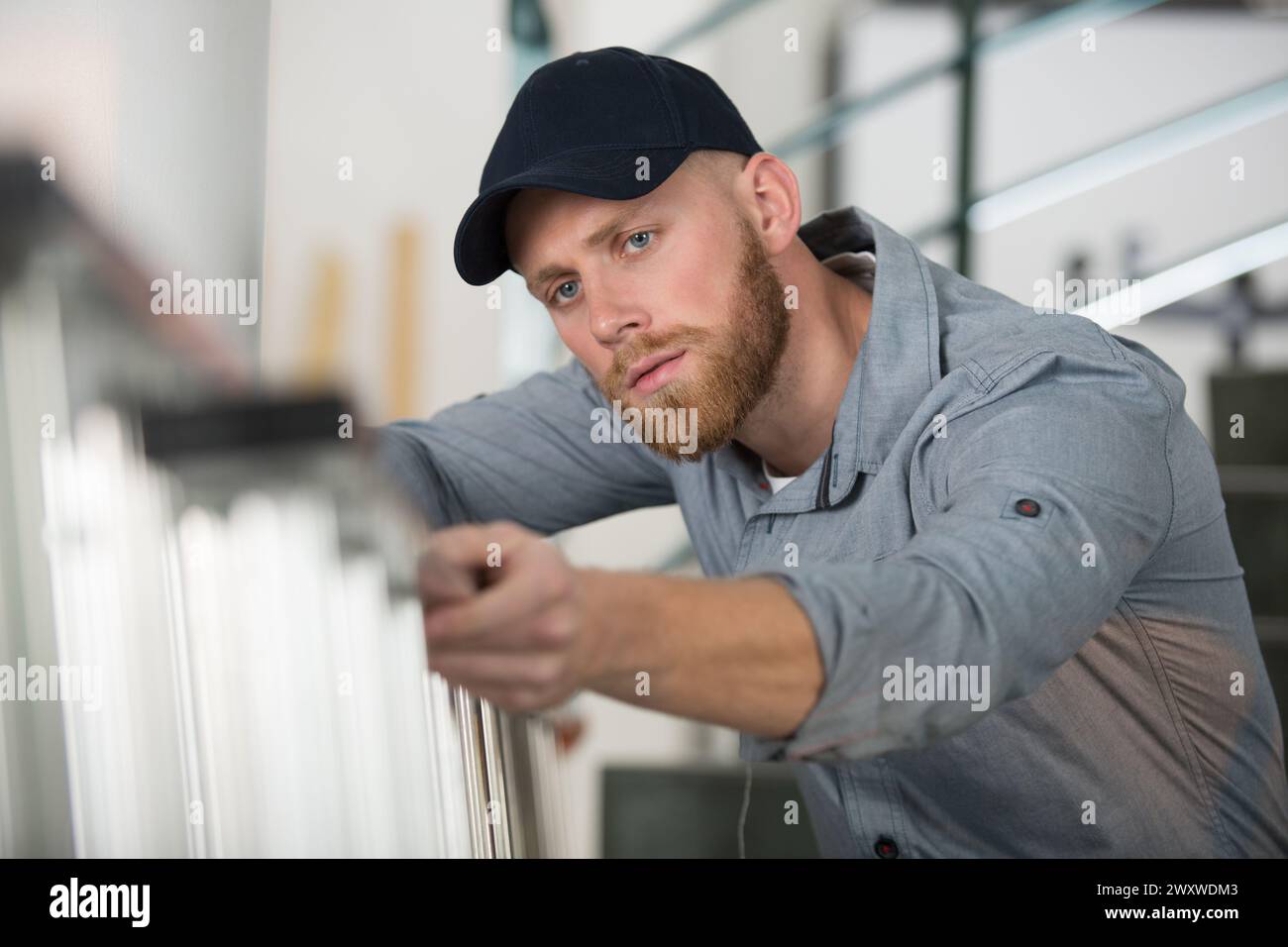 a foreman checking the state of a ladder Stock Photo - Alamy