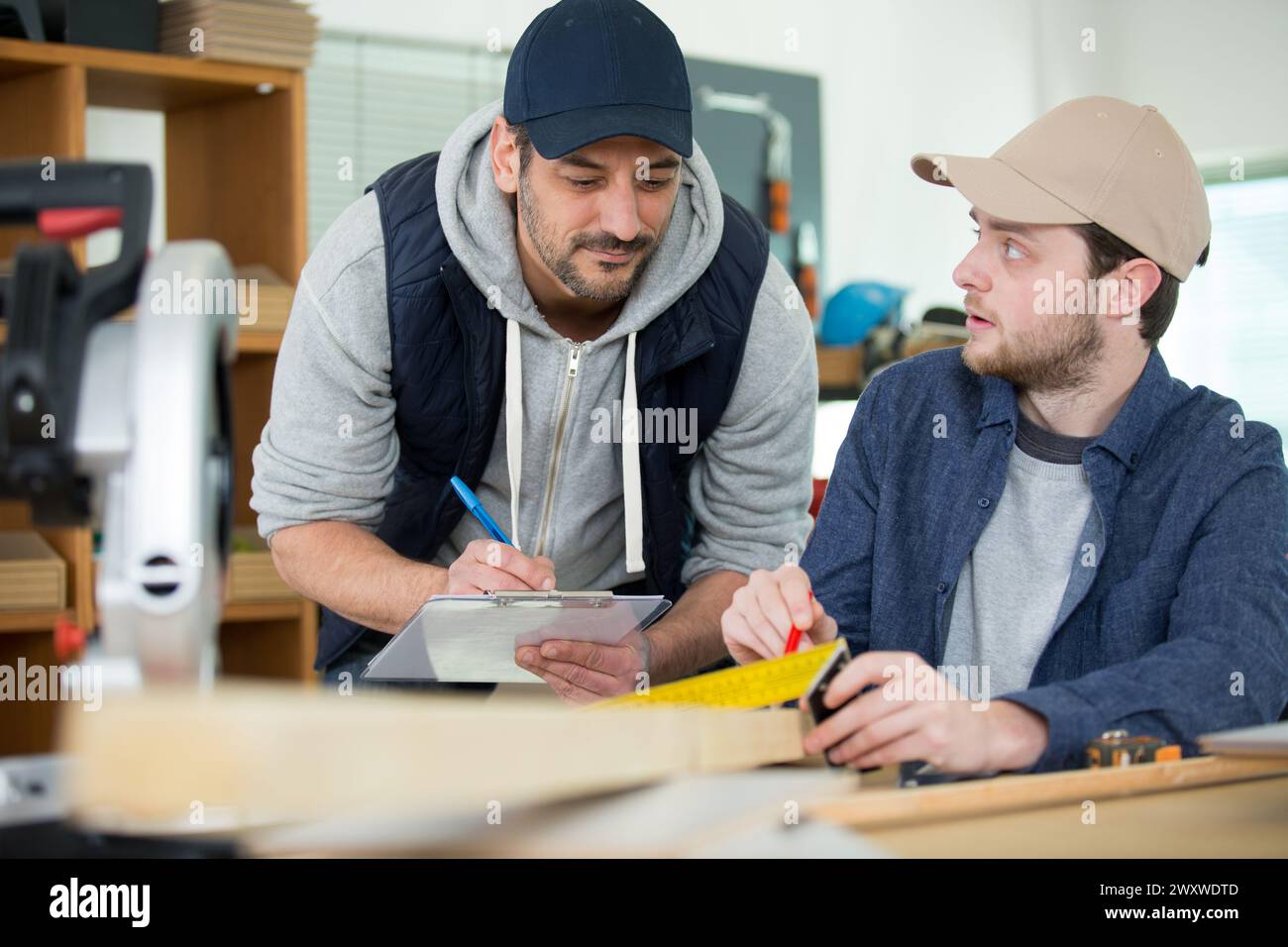 carpenter with apprentice in training period Stock Photo