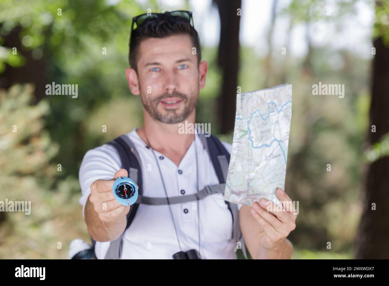 traveler holding a compass and map Stock Photo