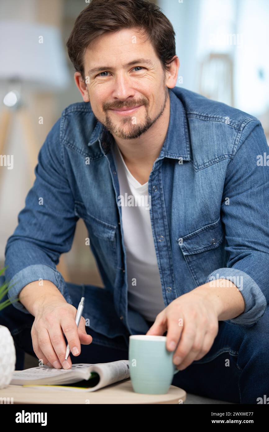 selective focus of man with dyslexia holding pencil and crossword Stock