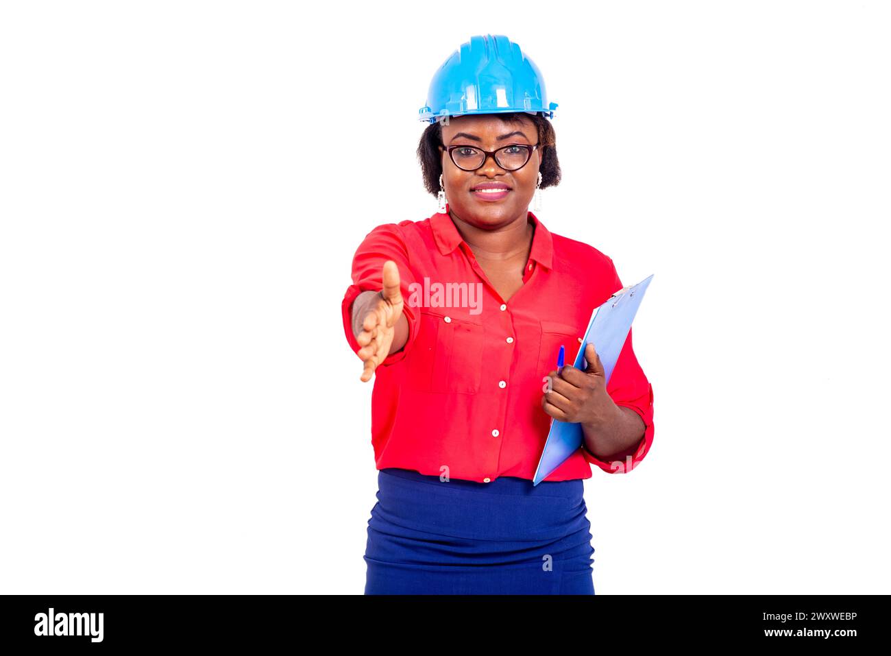 beautiful female engineer wearing blue safety helmet, holding clipboard ...