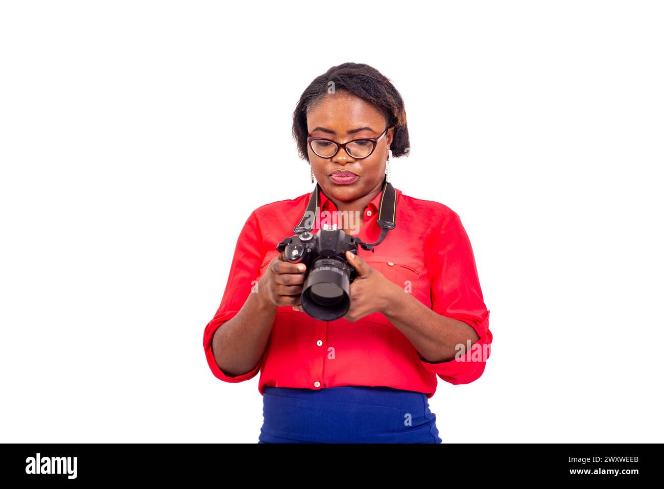 portrait of a beautiful young woman looking at the images taken on the digital camera. Stock Photo