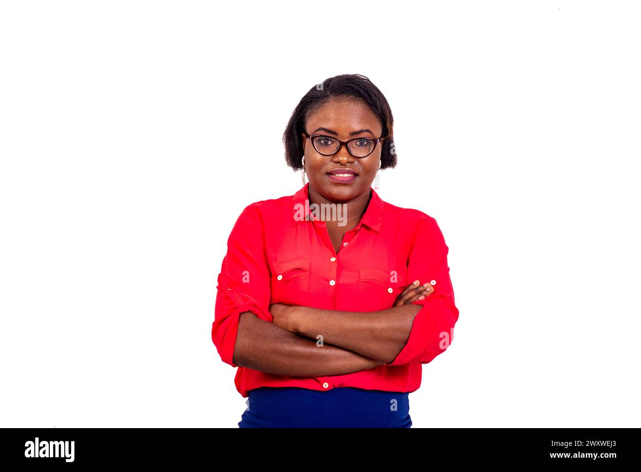portrait of a beautiful young businesswoman wearing optical glasses and crossing her arms while smiling. Stock Photo