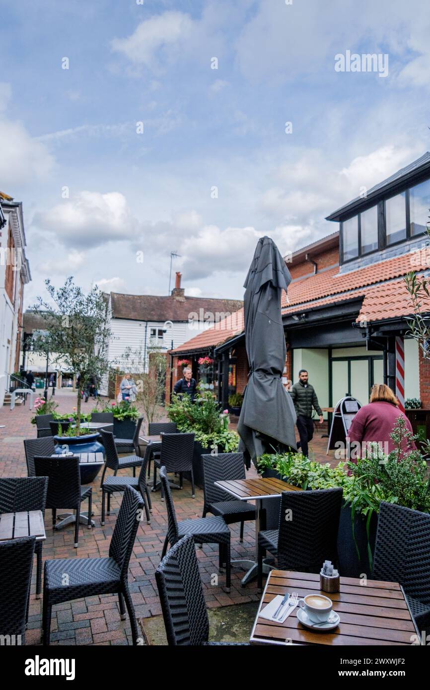 Epsom Surrey, UK, April 02 2024, People Walking Past Empty Outside Seating Area Cafe or Coffee Shop With No Customers Stock Photo
