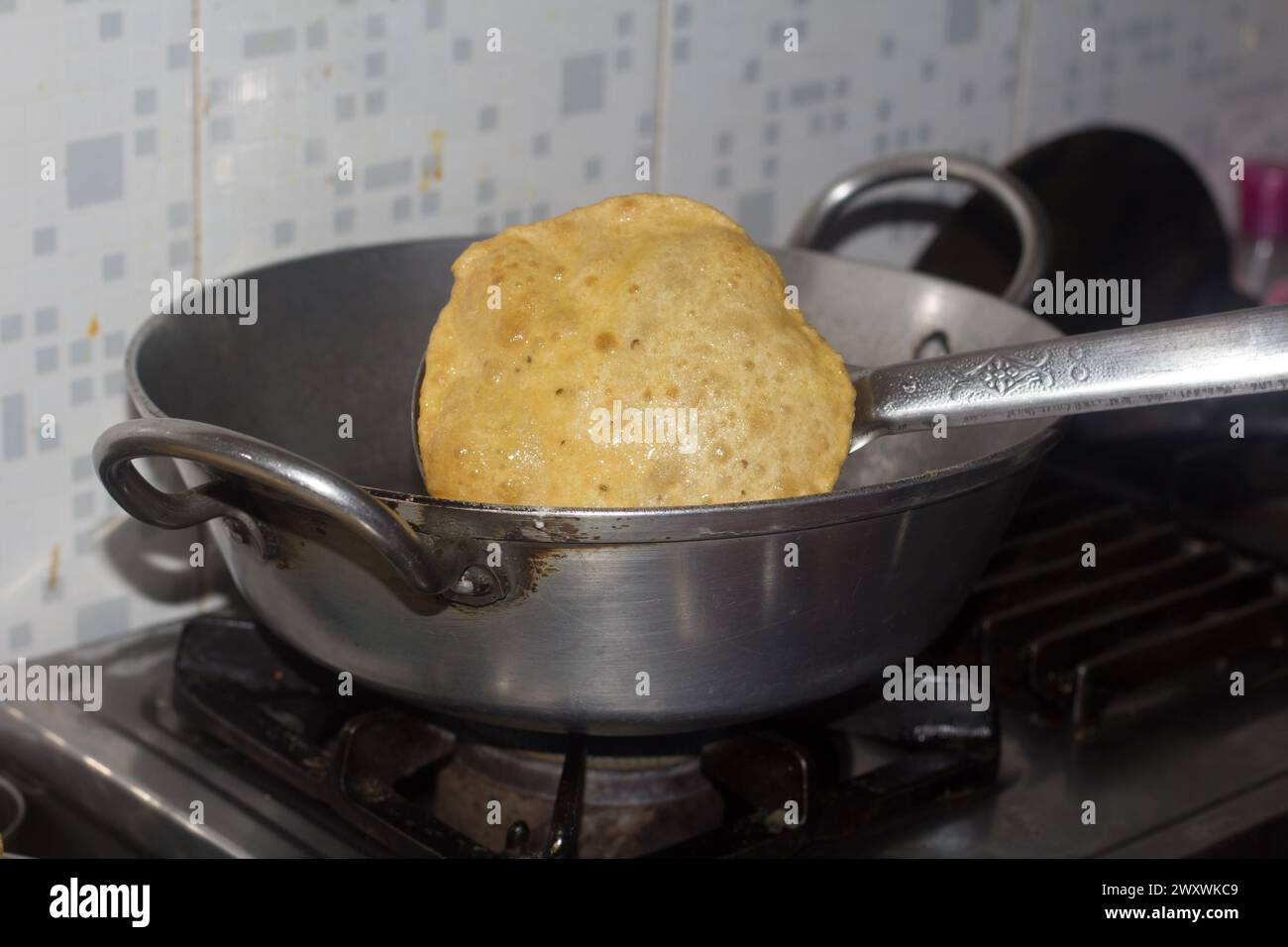 A fried Puri in a frying pan. very popular street food in India.famous indian food Stock Photo
