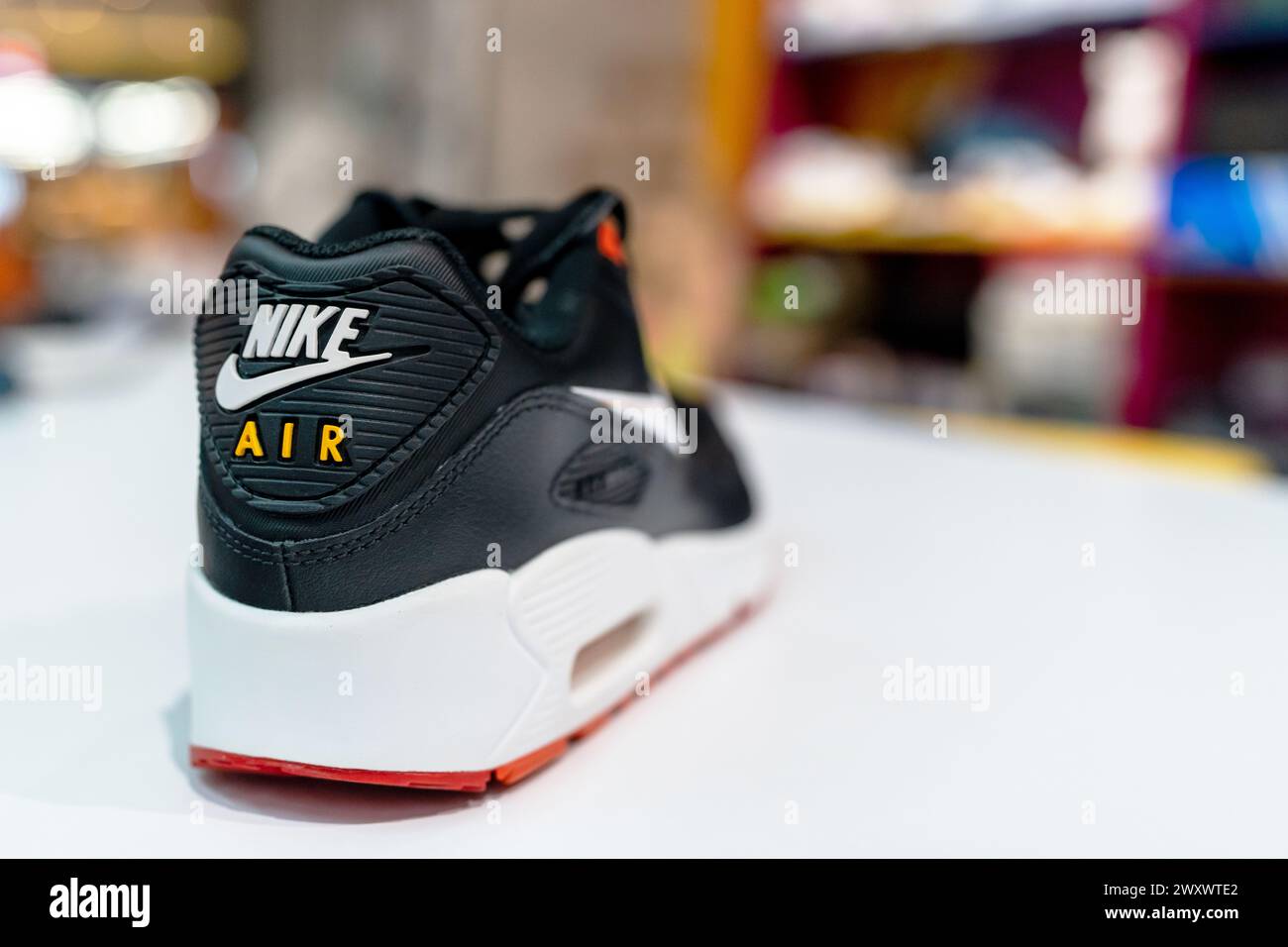 Nike Air logo on branded shoes. Nike Air sneakers on sports store shelf. Minsk, Belarus - January 21, 2024 Stock Photo