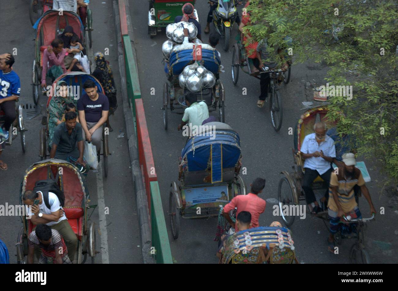 Hasan Reksha Dhaka, Bangladesh. 3rd Apr, 2024. Rickshaw passengers travel along a ...