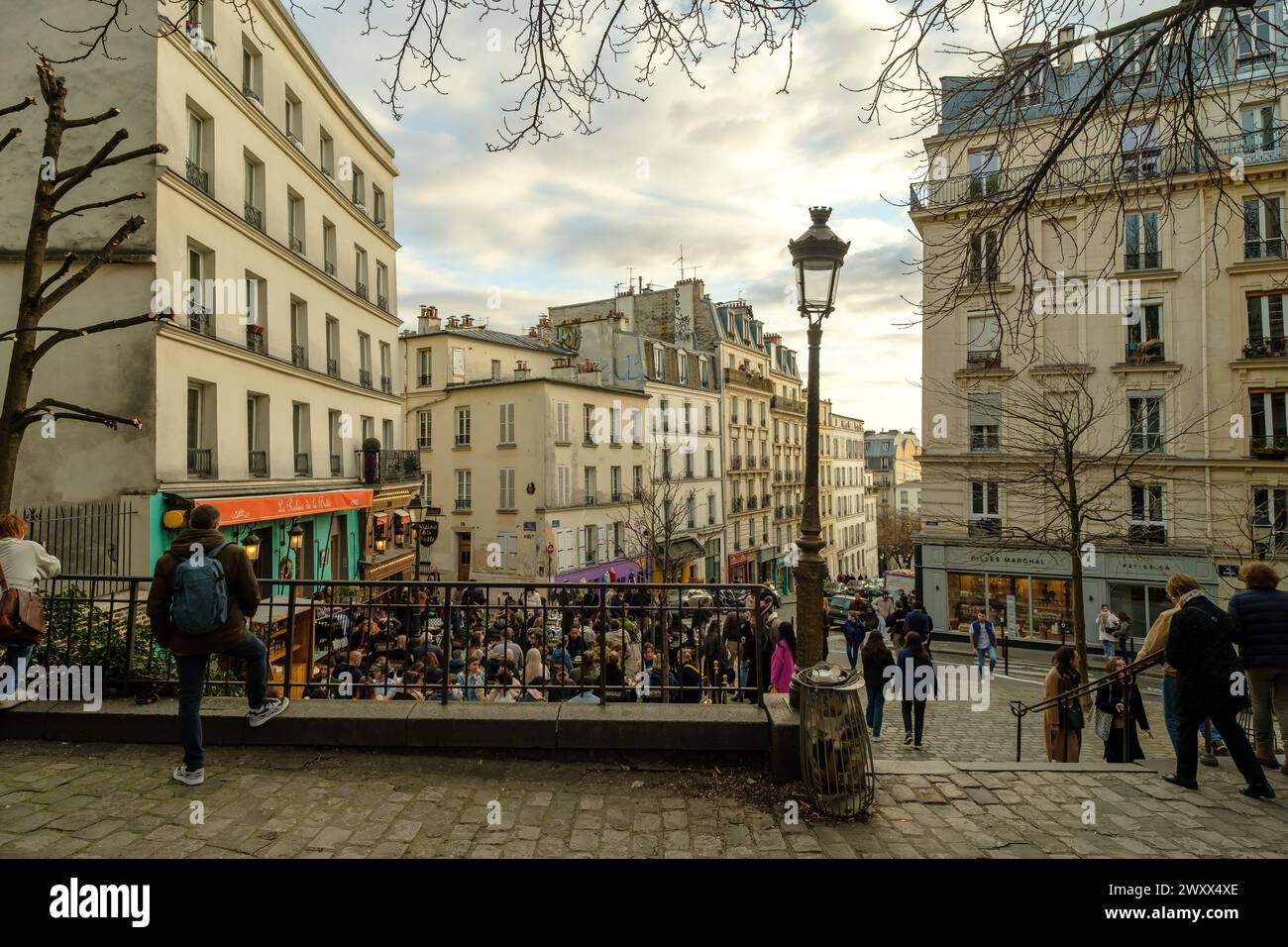 Paris, France - February 17, 2024 : View of people sitting outdoors and enjoying dinner and drinks at a cafe restaurant bistro in Paris France Stock Photo