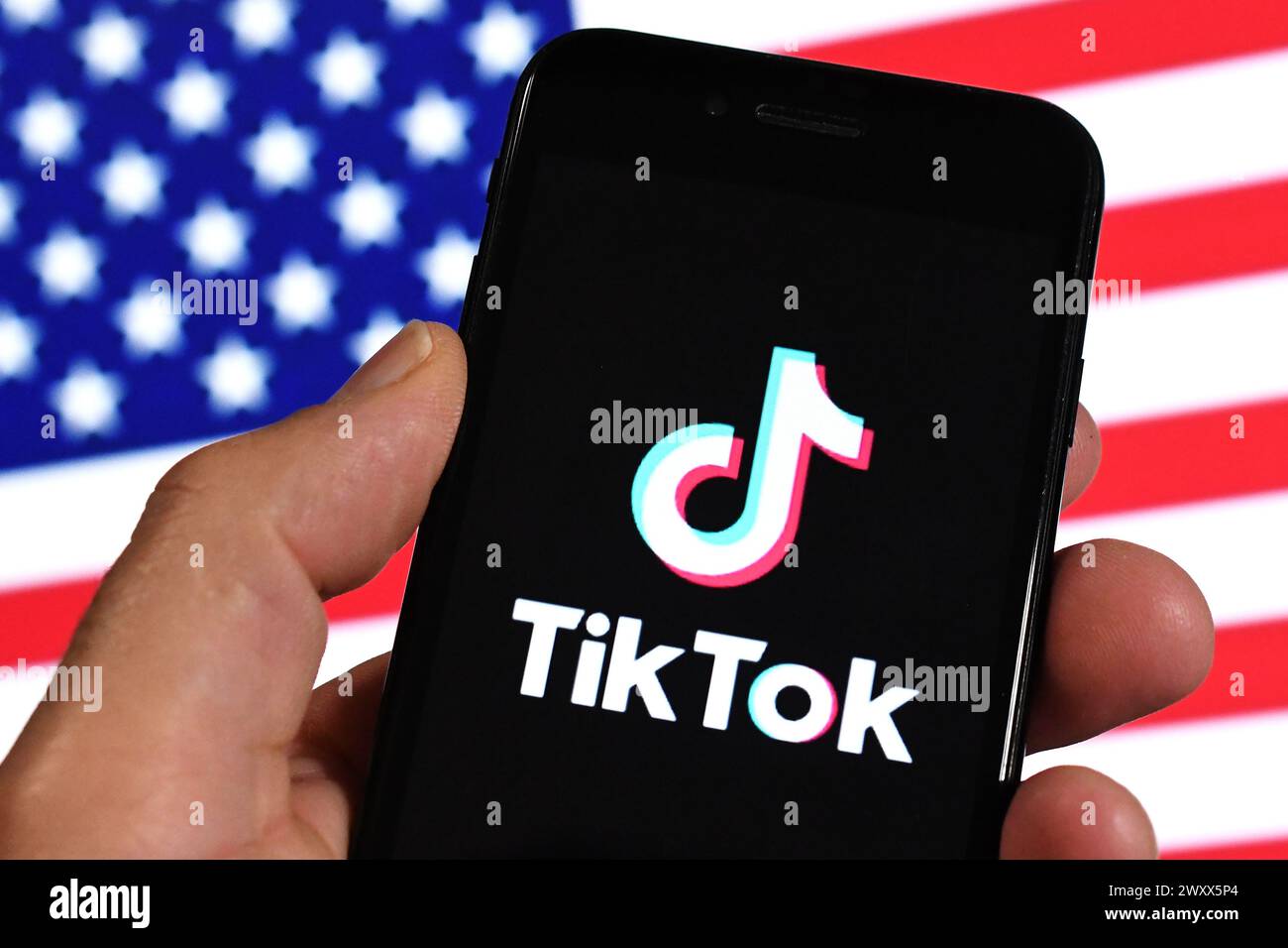 Logo of TikTok, a mobile app and social network for creating and sharing short videos by ByteDance company is seen on the screen of an smartphone. The Stock Photo