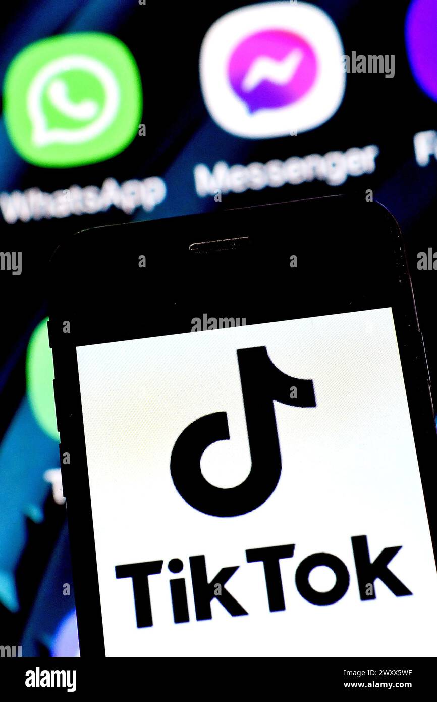 Logo of TikTok, a mobile app and social network for creating and sharing short videos by ByteDance company is seen on the screen of an smartphone.  Th Stock Photo