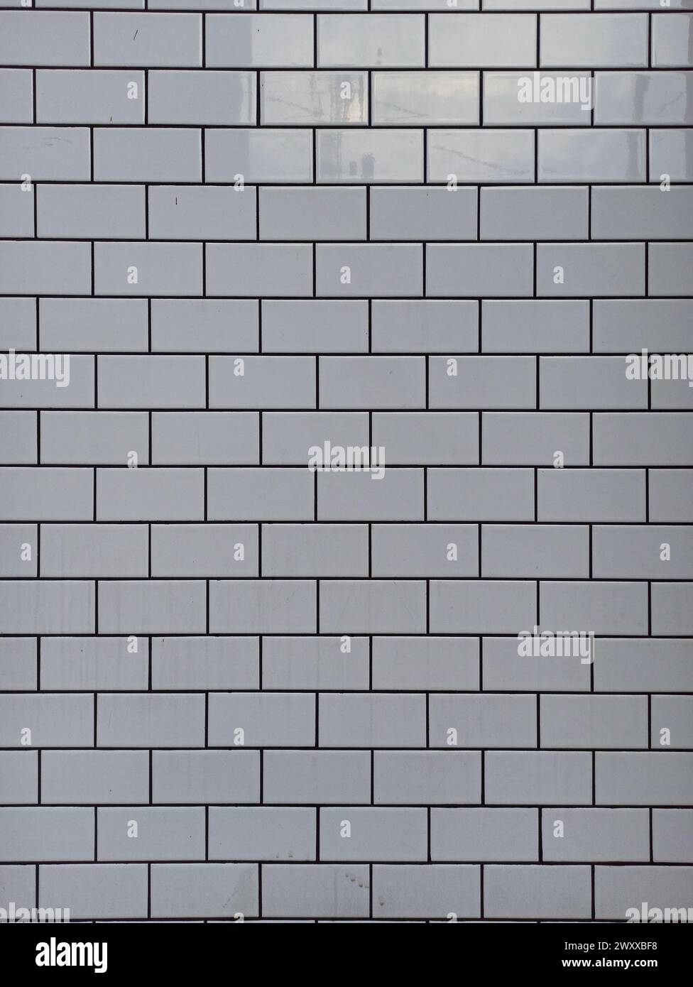 Texture of white ceramic tiles in the form of wall bricks Stock Photo
